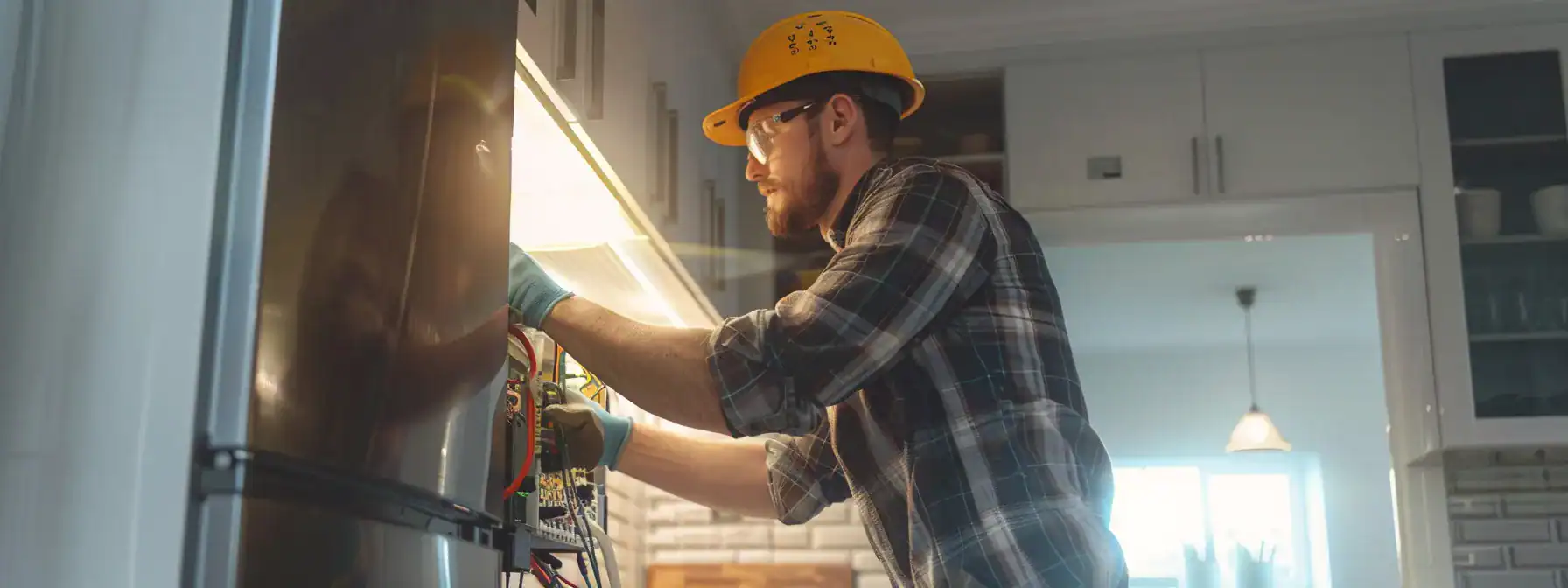 a professional electrician installing a new electrical panel in a modern kitchen.